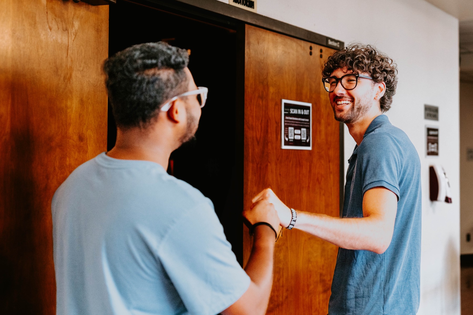 A student being welcomed at the door
