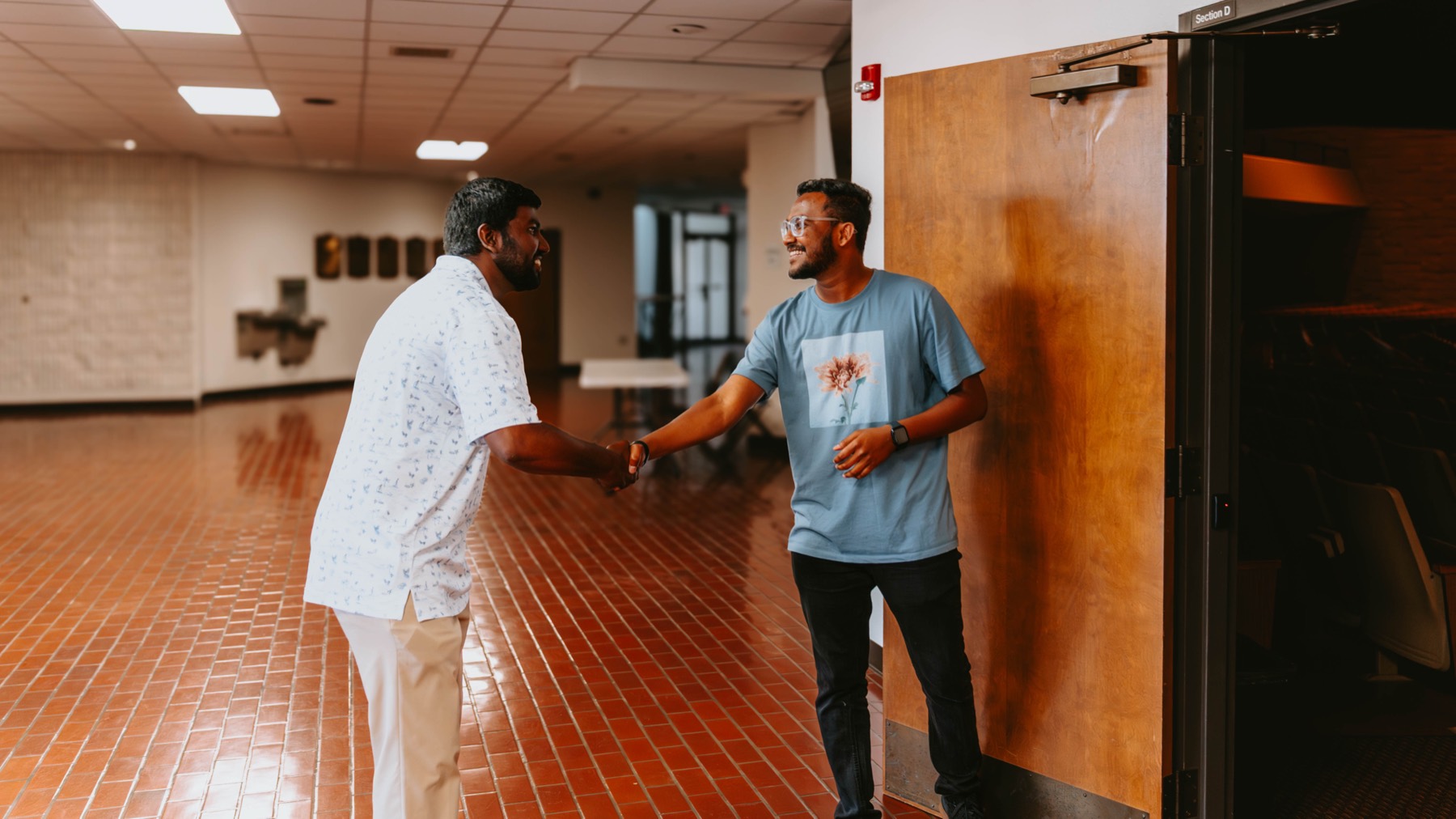 A student being welcomed with a handshake